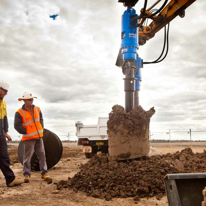 Auger Torque Earth Drills attached to an auger excavating dirt