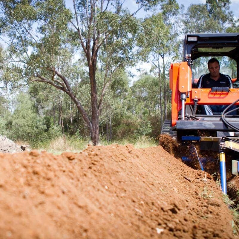 The Auger Torque Trencher attachment being used
